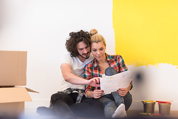 Image showing Happy young couple relaxing after painting