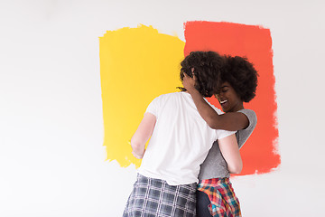 Image showing multiethnic couple painting interior wall