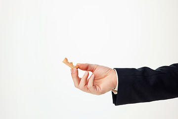 Image showing Man\'s hands holding wooden puzzle.