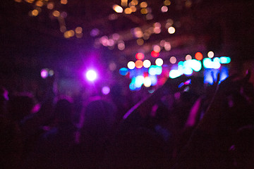 Image showing The silhouettes of concert crowd in front of bright stage lights