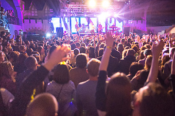 Image showing The silhouettes of concert crowd in front of bright stage lights