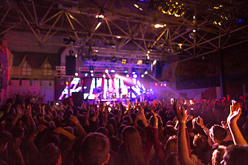 Image showing The silhouettes of concert crowd in front of bright stage lights