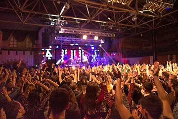 Image showing The silhouettes of concert crowd in front of bright stage lights