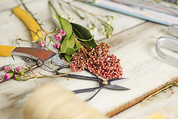 Image showing The florist desktop with working tools on white background