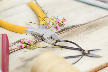 Image showing The florist desktop with working tools on white background