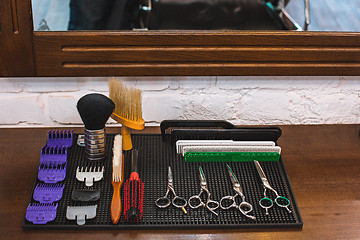 Image showing Barber shop equipment on wooden background.