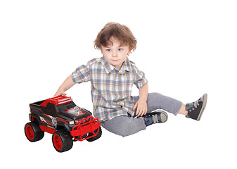 Image showing Sweet three year boy playing with his truck.