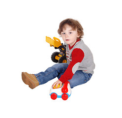 Image showing Little boy playing with his toys.