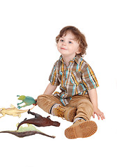 Image showing Smiling little boy with his toys.