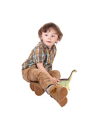 Image showing Pretty little boy sitting on floor.