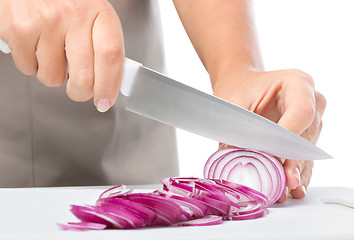 Image showing Cook is chopping onion