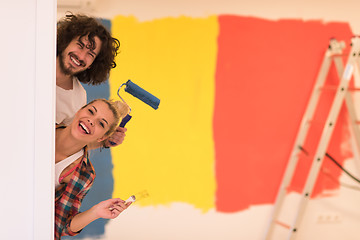 Image showing portrait of a couple painting interior wall