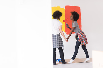 Image showing multiethnic couple painting interior wall