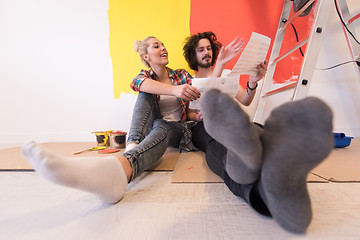 Image showing Happy young couple relaxing after painting