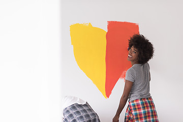 Image showing multiethnic couple painting interior wall