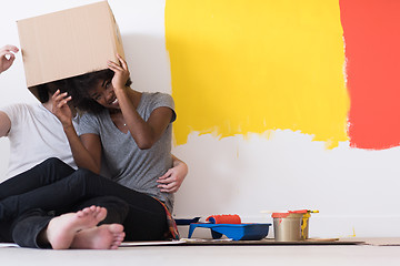 Image showing young multiethnic couple playing with cardboard boxes