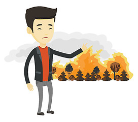 Image showing Man standing on the background of wildfire.