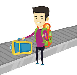 Image showing Man picking up suitcase on luggage conveyor belt