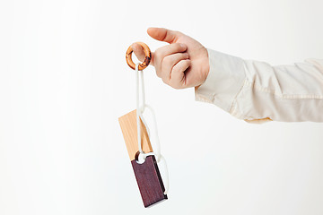 Image showing The toy wooden puzzle in hand isolated on white background