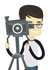 Image showing Cameraman with movie camera on tripod.