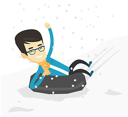 Image showing Man sledding on snow rubber tube in the mountains.