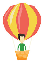 Image showing Young man flying in hot air balloon.