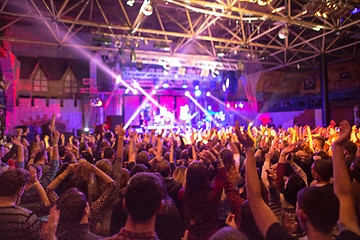 Image showing The silhouettes of concert crowd in front of bright stage lights