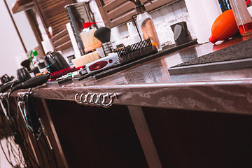 Image showing Barber shop equipment on wooden background.