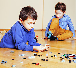 Image showing funny cute children playing toys at home, boys happy smiling, first education role lifestyle 