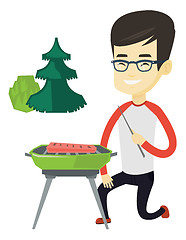 Image showing Man cooking steak on barbecue grill.