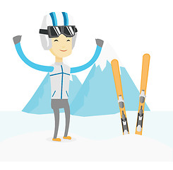 Image showing Cheerful skier standing with raised hands.