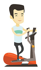 Image showing Man exercising on elliptical trainer.