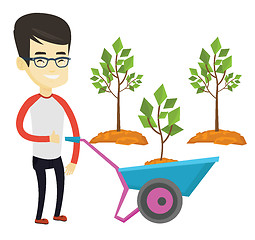 Image showing Man pushing wheelbarrow with plant.