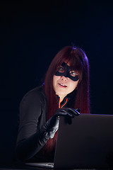 Image showing Thief in mask with laptop