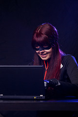 Image showing Girl in mask steals information