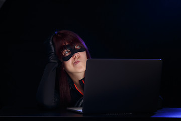 Image showing Young woman hacker with laptop