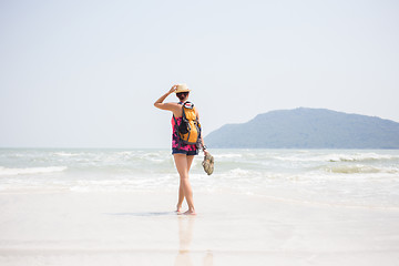 Image showing Young girl in hat on seashore