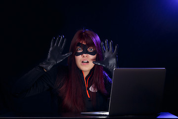 Image showing Girl spy with raised hands