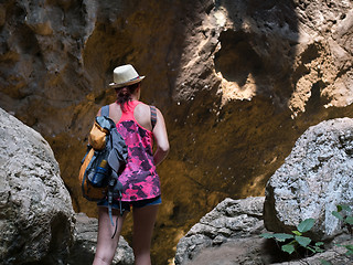 Image showing Girl with backpack among rocks