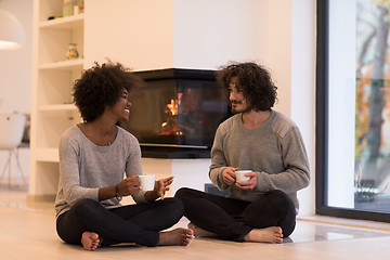 Image showing multiethnic couple  in front of fireplace