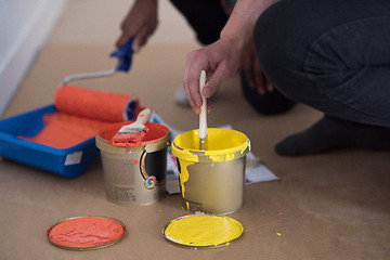 Image showing painters prepare color for painting