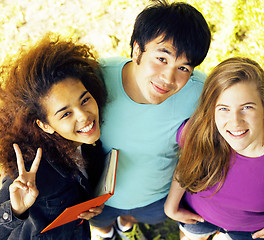 Image showing cute group of teenages at the building of university with books 