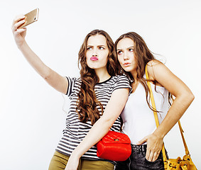 Image showing lifestyle people concept: two pretty stylish modern hipster teen girl having fun together, happy smiling making selfie