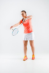 Image showing Young woman playing badminton over white background