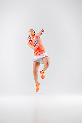 Image showing Young woman playing badminton over white background