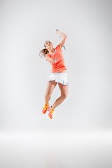 Image showing Young woman playing badminton over white background