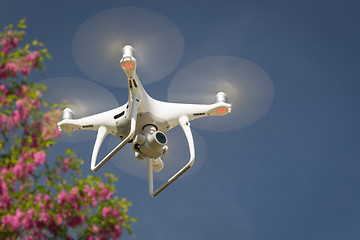 Image showing Unmanned Aircraft System (UAV) Quadcopter Drone In The Air.