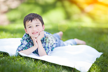 Image showing Mixed Race Chinese and Caucasian Young Boy Relaxing Outside On T