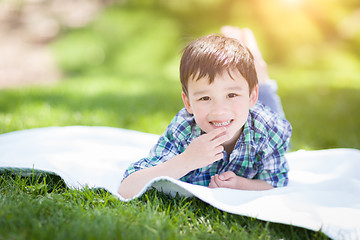 Image showing Mixed Race Chinese and Caucasian Young Boy Relaxing Outside On T