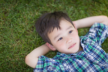 Image showing Thoughtful Mixed Race Chinese and Caucasian Young Boy Relaxing O